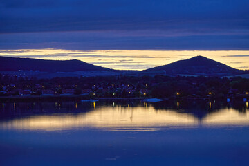 Lake Balaton at sunset with blue clouds and reflection on the water; color photo.