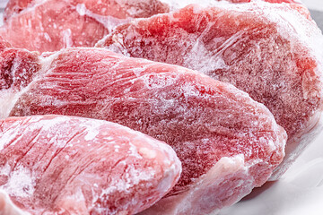 Raw frozen meat pieces. raw pork chops close-up