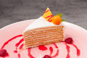 honey cake decorated with physalis and raspberries