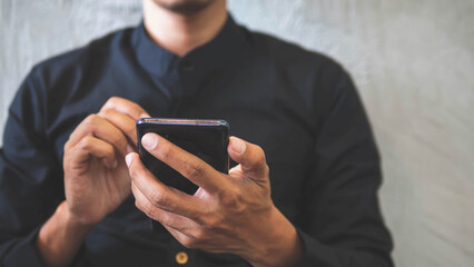 Close-up image of male hands using smartphone at coffee shop. searching or social networks concept.