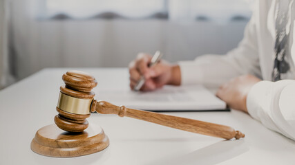 Lawyer with lawsuit meeting with client discussing with contract agreement at courtroom.