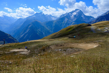 Fototapeta premium Hiking near ski station Les deux Alpes and view on Alpine mountains peaks in summer, Isere, France