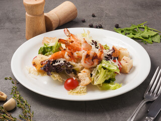 Caesar salad with shrimp. classic seafood salad