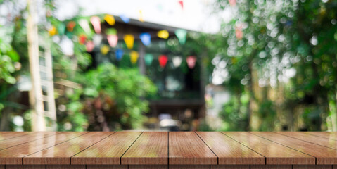 Empty wooden table top with lights bokeh on blur restaurant background	
