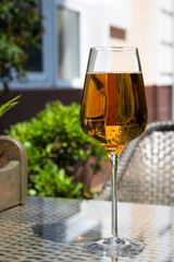 beer in a glass glass, which is intended for wine. The concept - it does not matter from which dishes to drink alcohol. Outdoor cafe in summer, soft drinks, beer, outdoor recreation, bar menu