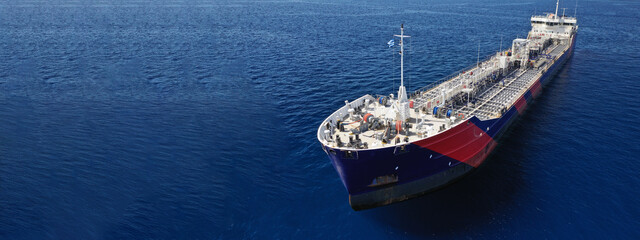 Aerial drone ultra wide panoramic photo of crude oil tanker carrier anchored in deep blue open...
