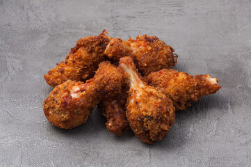fried crispy breaded chicken wings on a gray background