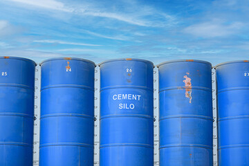 Cement mixing silo towers at under construction site. Storage of materials in the production of concrete.