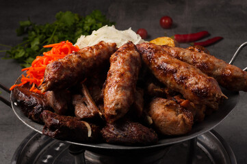 Kazan kebab-assorted meat, heated on the fire. Traditional Asian dish