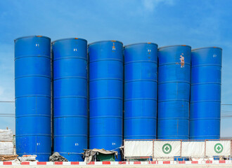 Cement mixing silo towers at under construction site. Storage of materials in the production of concrete.