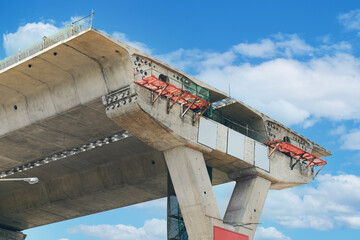 Fragment view of Highway overpass bridge structure, pillar concrete, work platform, scaffolding,...