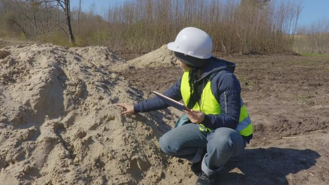 Woman civil inspector near unfinished landscaping works