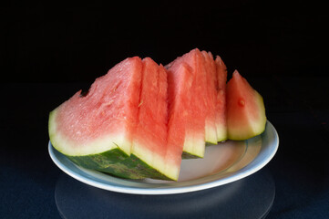 Ripe sliced watermelon on the table in a light plate