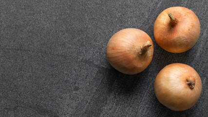 shallot onions on the dark stone background and have copy space for food ingredient concept menu, top view.