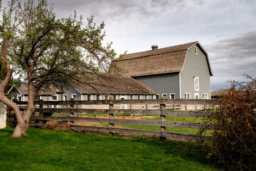 Fototapeta na wymiar Agriculture Dairy Barn and fence on a rural Idaho farm