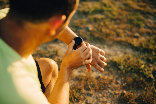 Cropped image of sportsman checking time on wristwatch