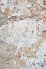 texture of an old peeling white wall, cracks, peeled off plaster