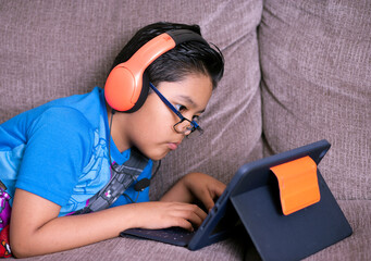 young man doing homework on laptop