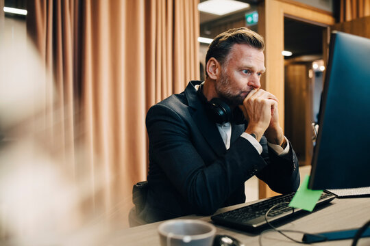 Worried businessman working on computer in office