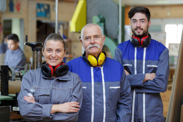 portrait of engineer and apprentice in factory