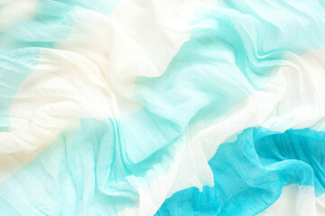 Beautiful natural airy fabric with white and blue waves, texture, abstract background.
