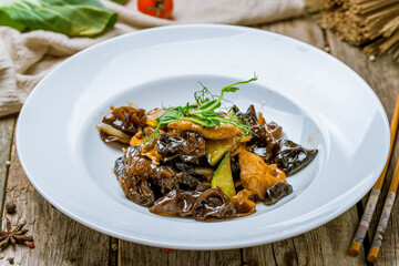 fried Meat with shiitake mushrooms on old wooden table, chinese cuisine