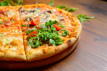 Close up of pizza garnished with arugola.