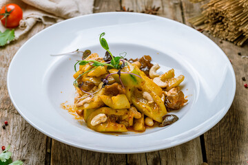 cucumbers sour and spicy with cashews, chinese cuisine on old wooden table