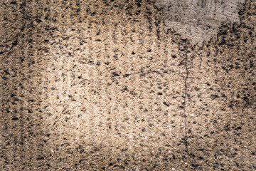 Old concrete wall with stones. Close up view