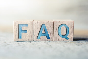 FAQ Written On Wooden Blocks On A Board - Need Help Concept