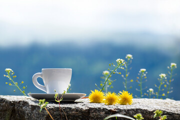 Summer morning among nature outdoor concept. Fresh composition with coffee cup and yellow...