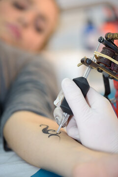 a female arm being tatooed