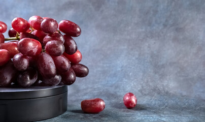 Red grapes on a blue vintage background. Copy space. High quality photo