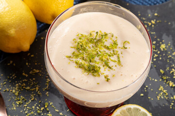 Lemon mousse in crystal bowl with lemon zest.