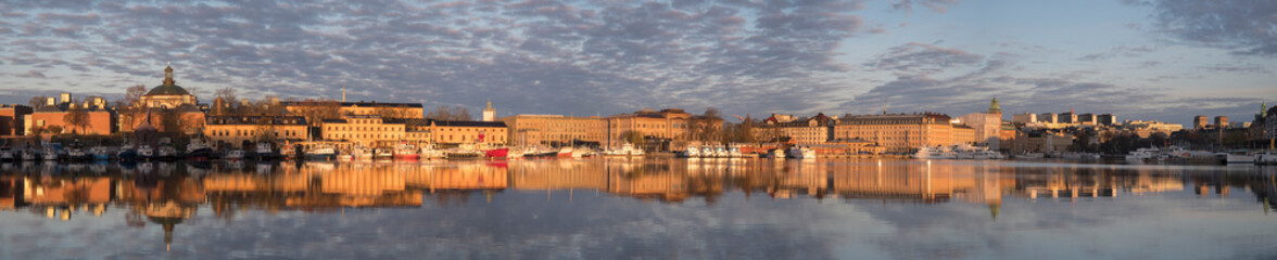 Morning spring view in the Stockholm harbor with boats and the old town Gamla Stan