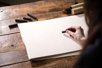 Close-up view of a painter on a white sheet. A man holds a pencil and draws. Drawing and creativity...