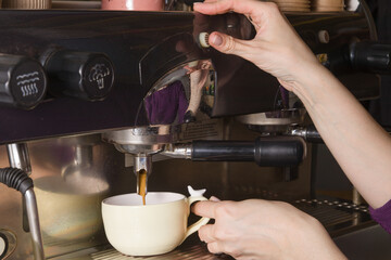 Fototapeta na wymiar Barista hands prepare coffee in a cup in a small coffee shop. Small business concept
