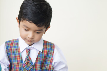 Cute Asian boy about 3 years old wearing a school uniform he has a happy face smile concept. 