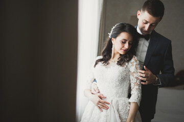 Perfect couple bride, groom posing and kissing in their wedding day