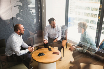 Business people planning strategy while discussing during meeting at office