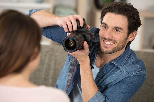 young man photographing fashion model