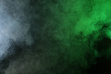 Artificial smoke in red-green light on black background