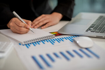 Close up of Businesswoman hands hold documents with financial statistic stock photo,discussion and analysis data the charts and graphs. Finance concept	