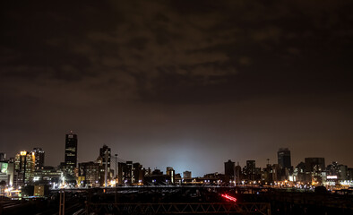 Night time view of commuter trains under Nelson Mandela Bridge in Braamfontein Johannesburg CBD