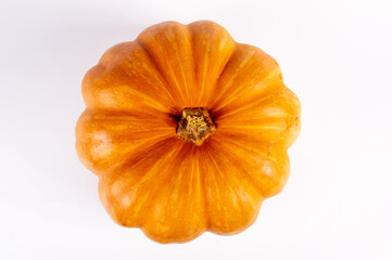 Whole fresh orange big pumpkin on white background, closeup. Organic agricultural product, ingredients for cooking, healthy food vegan.