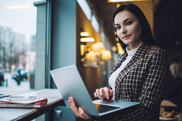 Female freelancer using computer in cafe