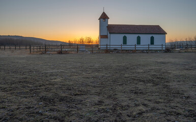 Fototapeta na wymiar Sunrise on McDougall Church on the Stoney Nakoda Nation at Morley, Alberta, Canada