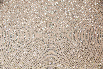 Abstract background of shiny rings of gray, black and beige colors with iridescent glitter.