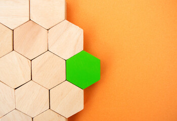 One green hexagon stands out from the rest. Leadership and victory concept. Dissimilarity and...