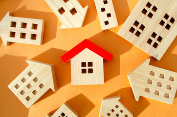 Many miniature wooden houses. Real estate concept. Choose affordable housing. Buying and selling...